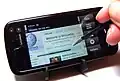 The Nokia 5800 displaying Wikipedia Mobile and its stylus pen