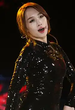 Image of Nicole singing dressed in black