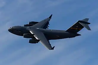 Bottom view of four-engine jet transport (C-141 Starlifter) in-flight.