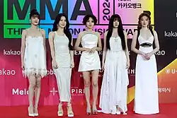 Image of I-dle members dressed in white