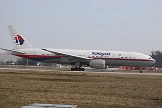 A Boeing 777 in Malaysia Airlines livery just after lifting off the runway