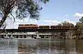 L class crossing the Swan river at Guildford in 2006, with a train of Portman iron ore.