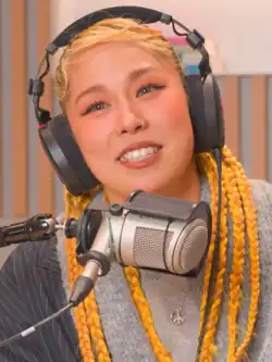 A still image of Ai during a podcast interview