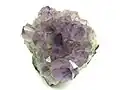 A cluster of light purple to violet amethyst crystals.