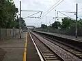 View northwards towards Conduit Lane, visible far in the distance beyond the station footbridge.
