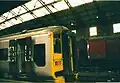 A Wessex Trains train in Bristol Temple Meads station with British Post Office wagons in the background during 2001