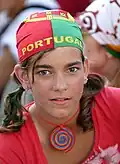 A Portuguese soccer fan wears a kerchief both as bandana and an expression of her club loyalty.