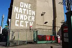 Banksy art next to a CCTV camera in London