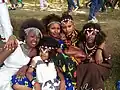 This photo represents the varieties of dressing and hairstyle of the Oromo culture. the kid sitting in front of the group dressed Guji Oromo clothes. the four girls at the back from left to right, dressed Harar, Kamise, Borena and Showa styles and all are Oromo style