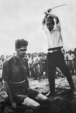 An Australian POW, Sgt Leonard Stiffleet, captured in New Guinea, about to be beheaded by a Japanese soldier with a guntō sword, 1943