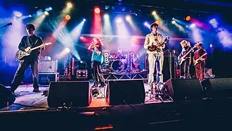 The band playing music on a stage