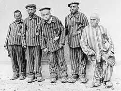 Jewish people with disabilities at Buchenwald in 1938. They wore black triangles on a yellow triangles, marking them as 'asocial' Jews