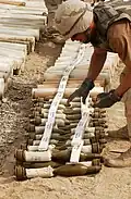 A soldier prepares a load of C4, to destroy ammunition found at a site.