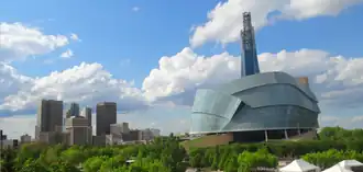 Downtown skyline alongside a building with a curved glass facade