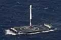 A first-stage booster rocket (Falcon 9, serial number B1021) after landing from a flight in 2016. This rocket landed on a drone ship.