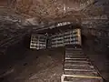 Cheddar cheese is being matured in a cave.
