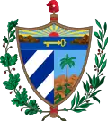 A shield in front of a Fasces crowned by the Phrygian Cap, all supported by an oak branch and a laurel wreath