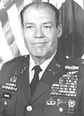 A black-and-white photo of older balding white man in his dress military uniform without a hat