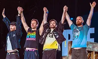 Four men prepare to bow after performing