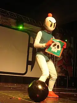 A cosplay of Bomberman, holding a skull item.