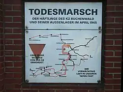 A red triangle on a historical marker. The marker shows the route prisoners were forced to take on the Buchenwald death march (Todesmarsch).
