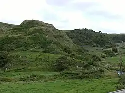 Three grassy mounds, at the location of the former Castle known as the 'Gates of Erris', home to the Barons of Irrus