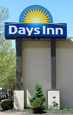 Sign saying Days Inn with a sun behind it.