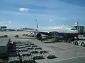 A United Airlines Boeing 777 parked at the terminal.