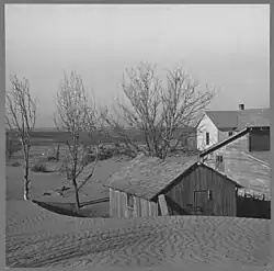 Dust starting to bury a barn in Kansas