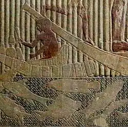 Electric catfish (center) in bas-relief