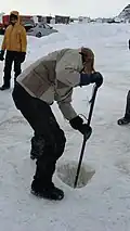 Ice chiseling a hole in Quebec