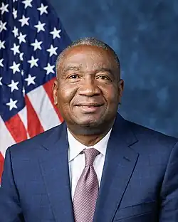 Official House portrait of Fields smiling in front of the U.S. flag, wearing a dark blue suit, white shirt, and checkered red and blue tie.