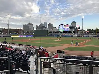 A baseball game being during the day
