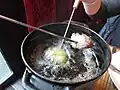 The meat is cooked in oil or broth[permanent dead link].