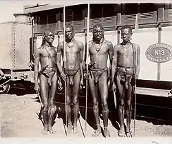 Ethnographic photo, but modern background: Four Masai tribesmen, about 1900