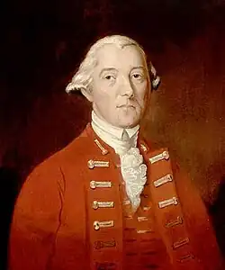 A half-height oil portrait of Carleton. He faces front, wearing a red coat and vest over a ruffled white shirt. His hair is white, and is apparently pulled back.