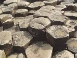 Naturally formed basalt columns from Giant's Causeway in Ireland; large masses must cool slowly to form a polygonal fracture pattern