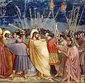 Jesus is kissed by Judas as a sign to the guards who have come to arrest him.