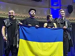 Image of Go_A members holding the flag of Ukraine