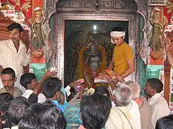 Famous Hanuman Garih temple. A Young Priest is operating the Darshan system.