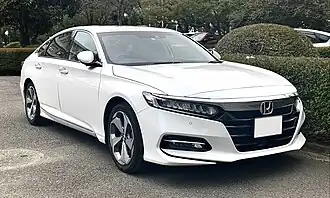 Front three-quarter view of a front-engined four-door car.