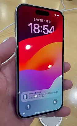 A iPhone 15 using iOS 17 with lock screen