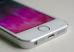 The front of an iPhone 5s show a circular home button.