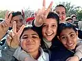 Iraqi boys making the V sign in Baghdad.