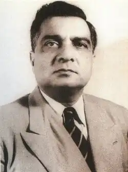 A black and white portrait of Iskander Mirza