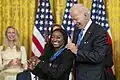 Olympic champion Simone Biles receiving the Presidential Medal of Freedom from President Joe Biden in 2022