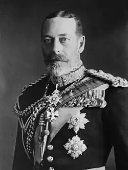 George V is pale-eyed, grey-bearded, of slim build and wearing a uniform and medals