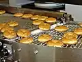 Glazed doughtnuts being made at a Krispy Kreme factory