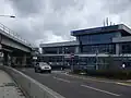 Main entrance to the Airport and Station (DLR sign visible near bridge)