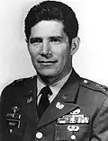 A head and shoulders portrait of a cleanshaven man with dark hair, wearing a military uniform.